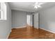 Spacious bedroom with hardwood floors and a connecting doorway offering a peek into other rooms at 1230 Shearers Rd, Mooresville, NC 28115
