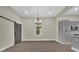 Bright dining area featuring a modern chandelier, sliding barn door, and sleek hardwood floors at 126 Hemphill Ave, Chester, SC 29706