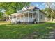 Side view of a quaint home with covered porch and grassy yard at 126 Hemphill Ave, Chester, SC 29706