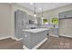 Bright kitchen with gray cabinets, center island, stylish pendant lights, and stainless steel appliances at 126 Hemphill Ave, Chester, SC 29706