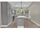Spacious kitchen featuring gray cabinets, white marble island, stainless appliances, and stylish pendant lighting at 126 Hemphill Ave, Chester, SC 29706