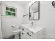 All-white bathroom features a modern vanity with dark hardware at 1327 Fairmont St, Charlotte, NC 28216
