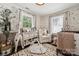 Bright Bedroom with safari wallpaper, a crib, stuffed animals and ample natural light at 1327 Fairmont St, Charlotte, NC 28216