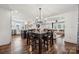 Open concept dining area with wood floors, modern lighting, and view to living room and kitchen at 1327 Fairmont St, Charlotte, NC 28216