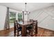 Dining area features decorative wall, wood floors, chandelier and natural light at 1327 Fairmont St, Charlotte, NC 28216