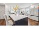 Modern kitchen featuring a large island with seating, white cabinetry, and stainless steel appliances at 1327 Fairmont St, Charlotte, NC 28216