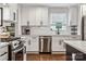 Well-lit kitchen with stainless steel appliances, white cabinetry, and ample counter space for cooking at 1327 Fairmont St, Charlotte, NC 28216