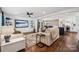Open-concept living room with hardwood floors, stylish furnishings, and seamless flow to the dining area and kitchen at 1327 Fairmont St, Charlotte, NC 28216