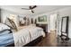 Comfortable main bedroom features dark wood floors, ceiling fan, and double closets at 1327 Fairmont St, Charlotte, NC 28216