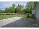 Wooden deck with railing, offering outdoor relaxation and views of the lush backyard at 1501 Nc Hwy 73 Hwy, Iron Station, NC 28080