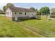Large backyard showcasing the home's stone foundation, wooden deck, and fenced-in perimeter at 1501 Nc Hwy 73 Hwy, Iron Station, NC 28080