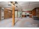 Finished basement featuring wood paneling, drop ceiling, kitchenette, and open layout for flexible living at 1501 Nc Hwy 73 Hwy, Iron Station, NC 28080