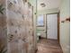 Bathroom with light green walls, grab bar, white toilet, and a window for natural light at 1501 Nc Hwy 73 Hwy, Iron Station, NC 28080