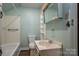 Bathroom featuring a tub, toilet, sink vanity with mirrored medicine cabinet, and light green walls at 1501 Nc Hwy 73 Hwy, Iron Station, NC 28080