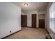 This cozy bedroom has neutral walls, carpet, and dark trim, with 3 doors for convenient access at 1501 Nc Hwy 73 Hwy, Iron Station, NC 28080