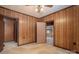 Bedroom featuring wood paneling, carpet, and multiple doorways providing access to different parts of the house at 1501 Nc Hwy 73 Hwy, Iron Station, NC 28080