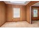 Bedroom featuring wood paneling, a skylight, and a window for natural light at 1501 Nc Hwy 73 Hwy, Iron Station, NC 28080