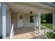 Covered front porch featuring white columns and railings, stone accents, and space for outdoor enjoyment at 1501 Nc Hwy 73 Hwy, Iron Station, NC 28080