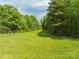 Expansive land featuring lush greenery and trees, offering a private and serene setting at 1501 Nc Hwy 73 Hwy, Iron Station, NC 28080