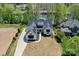 Aerial view of luxury home with dark roof on waterfront property surrounded by lush trees at 153 High Hills Dr, Mooresville, NC 28117