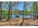 Backyard with a view of the lake and boat docks framed by mature trees at 153 High Hills Dr, Mooresville, NC 28117