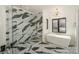 Modern bathroom featuring black and white marble design, glass enclosed shower, and a soaking tub with gold fixtures at 153 High Hills Dr, Mooresville, NC 28117