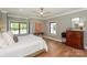 Calm bedroom with hardwood floors, gray walls, and large windows at 153 High Hills Dr, Mooresville, NC 28117