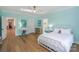 Bedroom with light blue walls, hardwood floors, and a white bed frame at 153 High Hills Dr, Mooresville, NC 28117