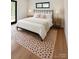 Inviting bedroom featuring a comfortable bed, stylish rug, and ample natural light at 153 High Hills Dr, Mooresville, NC 28117
