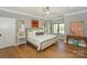 Serene bedroom with hardwood floors, neutral colors, and modern decor at 153 High Hills Dr, Mooresville, NC 28117