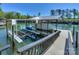 Lakefront boat dock featuring a covered boat slip and lift with aluminum ramps at 153 High Hills Dr, Mooresville, NC 28117
