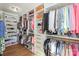 Spacious walk-in closet with custom shelves, drawers, and hanging rods for optimal organization and storage solutions at 153 High Hills Dr, Mooresville, NC 28117
