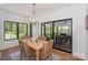 Cozy dining area with a wooden table and wicker chairs by a window at 153 High Hills Dr, Mooresville, NC 28117