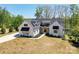 Stunning modern farmhouse featuring black window frames, black awnings and meticulous landscaping at 153 High Hills Dr, Mooresville, NC 28117