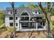 Expansive back of house with patio, balcony and large windows to maximize lake views at 153 High Hills Dr, Mooresville, NC 28117