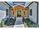 Inviting front entrance with wooden accents, black and white tile, and a stylish glass door at 153 High Hills Dr, Mooresville, NC 28117