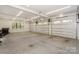 Spacious garage with concrete floors, three garage doors, and a side window at 153 High Hills Dr, Mooresville, NC 28117