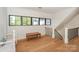 Hallway nook with a wooden bench, large windows, and staircase at 153 High Hills Dr, Mooresville, NC 28117