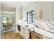 Modern kitchen with white cabinets, marble countertops, and stainless steel appliances at 153 High Hills Dr, Mooresville, NC 28117