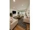 Spacious living room with a patterned rug, ample seating, and natural light at 153 High Hills Dr, Mooresville, NC 28117