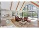 Open concept living room and kitchen with vaulted ceilings, wooden beams, and large picture windows at 153 High Hills Dr, Mooresville, NC 28117