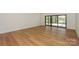 Bright living room featuring wood flooring and sliding glass doors with an outdoor view at 153 High Hills Dr, Mooresville, NC 28117