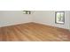 Bright living room featuring wood flooring, a window, and neutral decor at 153 High Hills Dr, Mooresville, NC 28117