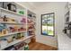 Walk-in pantry with ample shelving stocked with food items next to window at 153 High Hills Dr, Mooresville, NC 28117