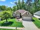 Expansive aerial view of a brick home with lush greenery and a well-maintained lawn at 1589 Essex Hall Dr, Rock Hill, SC 29730