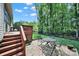 Inviting backyard featuring a charming patio set, lush greenery, and a serene wooded backdrop at 1589 Essex Hall Dr, Rock Hill, SC 29730