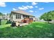 Expansive backyard with a well-maintained lawn, grilling area, and a deck for outdoor enjoyment at 1589 Essex Hall Dr, Rock Hill, SC 29730