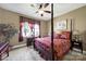 This bedroom features an antique canopy bed, window with curtains, and a ceiling fan at 1589 Essex Hall Dr, Rock Hill, SC 29730