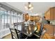 Dining room with bright natural lighting from large windows, hardwood floors, and an adjacent eat-in kitchen at 1589 Essex Hall Dr, Rock Hill, SC 29730