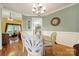 Dining room area with hardwood floors, an elegant chandelier, and access to the living space at 1589 Essex Hall Dr, Rock Hill, SC 29730
